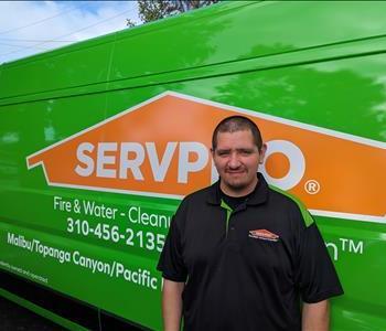 SERVPRO employee in front of green background