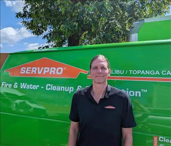 SERVPRO employee in front of green background